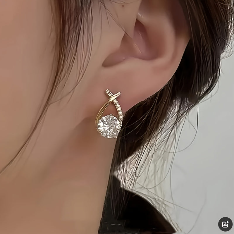 Orecchini con croce dorata e zirconia